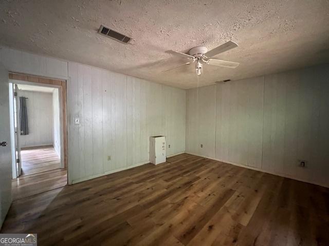 1041 Sandy Ridge Rd, Mcdonough, GA 30252 - empty room with wood finished floors, ceiling fan, and a textured ceiling