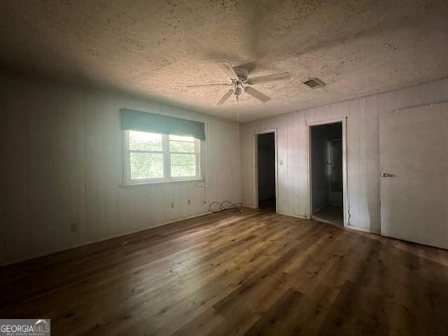1041 Sandy Ridge Rd, Mcdonough, GA 30252 - unfurnished bedroom featuring wood finished floors, a textured ceiling, and ceiling fan