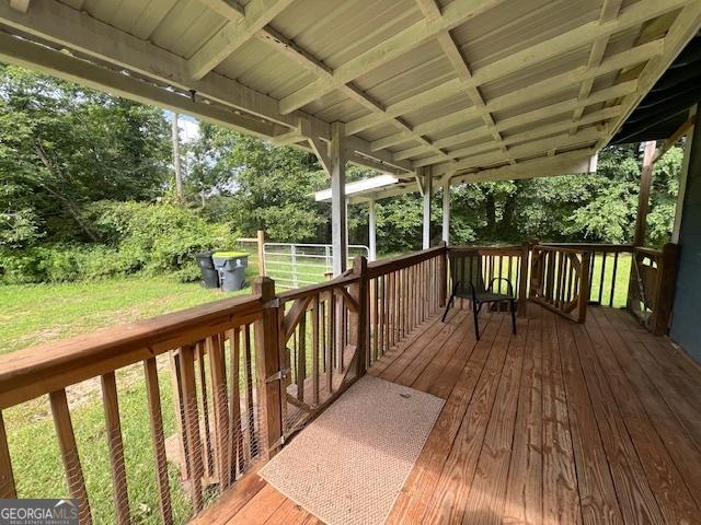 1041 Sandy Ridge Rd, Mcdonough, GA 30252 - wooden terrace featuring a lawn and view of wooded area