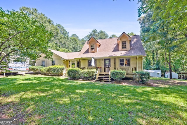 292 Selfridge Rd, Mcdonough, GA 30252 - cape cod house with a storage unit, a front lawn, and covered porch