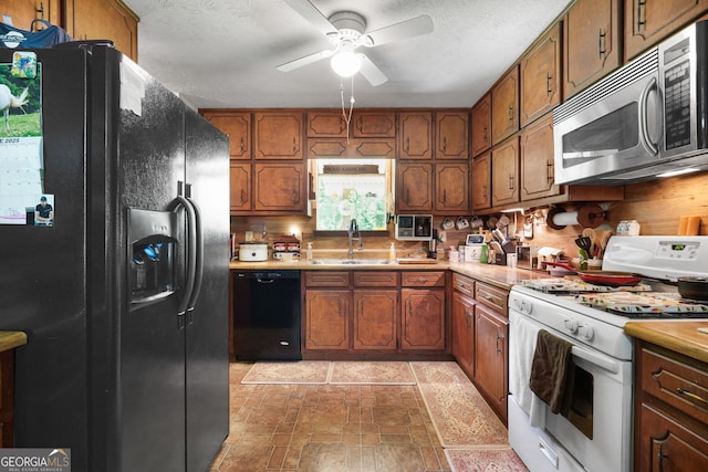 292 Selfridge Rd, Mcdonough, GA 30252 - kitchen with black appliances, ceiling fan, brown cabinets, light countertops, and a textured ceiling