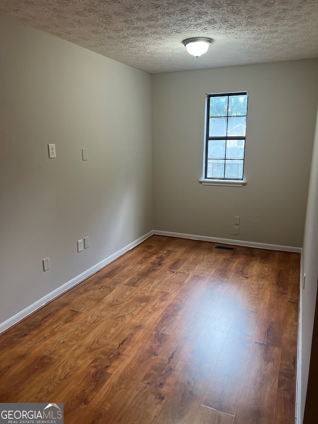 470 Huntington Rd Unit 5, Athens, GA 30606 - spare room featuring wood finished floors and a textured ceiling