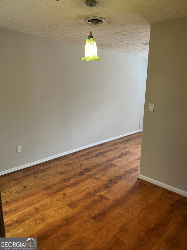 470 Huntington Rd Unit 5, Athens, GA 30606 - unfurnished room with a textured ceiling and dark wood-type flooring