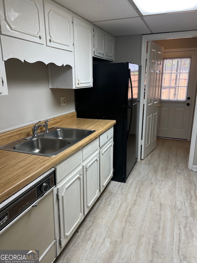 470 Huntington Rd Unit 5, Athens, GA 30606 - kitchen with dishwashing machine, white cabinets, light countertops, and freestanding refrigerator