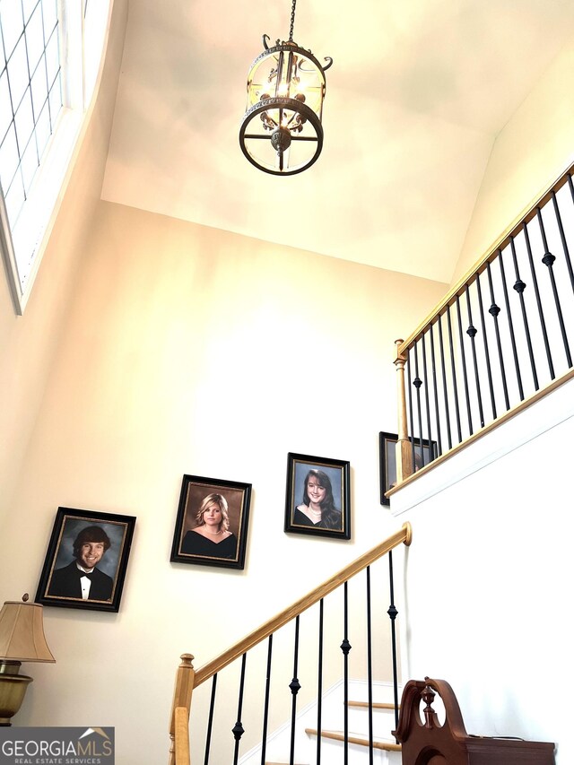 327 Highland Pointe Dr, Cohutta, GA 30710 - stairs featuring high vaulted ceiling and a chandelier