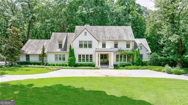 510 Heards Ferry Rd, Atlanta, GA 30328 - english style home with a front lawn, stucco siding, and view of scattered trees