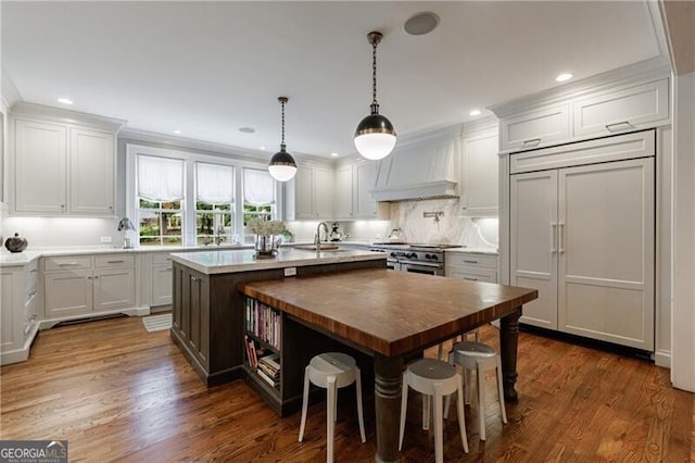 510 Heards Ferry Rd, Atlanta, GA 30328 - kitchen with custom range hood, high end appliances, an island with sink, dark wood-style flooring, and white cabinets