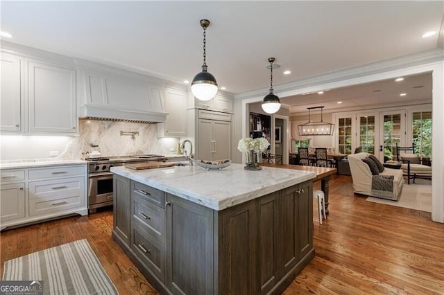 510 Heards Ferry Rd, Atlanta, GA 30328 - kitchen with high end appliances, dark wood-type flooring, decorative backsplash, white cabinetry, and crown molding