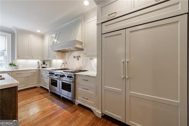 510 Heards Ferry Rd, Atlanta, GA 30328 - kitchen with range with two ovens, premium range hood, light wood-style flooring, tasteful backsplash, and recessed lighting