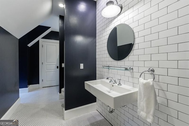510 Heards Ferry Rd, Atlanta, GA 30328 - bathroom with tile walls, vaulted ceiling, and tile patterned floors
