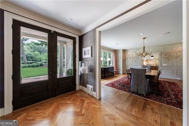 510 Heards Ferry Rd, Atlanta, GA 30328 - entrance foyer featuring ornamental molding, a chandelier, french doors, and a decorative wall