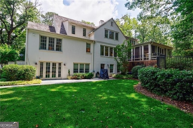 510 Heards Ferry Rd, Atlanta, GA 30328 - rear view of property featuring a sunroom, a lawn, french doors, stucco siding, and a chimney