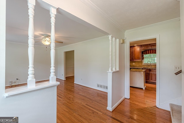 3109 Albatross Ln, Decatur, GA 30034 - unfurnished living room featuring crown molding, a ceiling fan, and light wood-style flooring