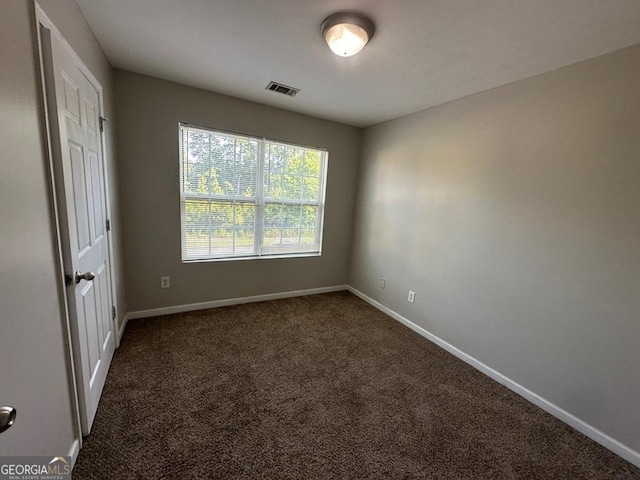 1017 Wheel House Ln Unit D, Monroe, GA 30655 - unfurnished bedroom with baseboards and dark carpet
