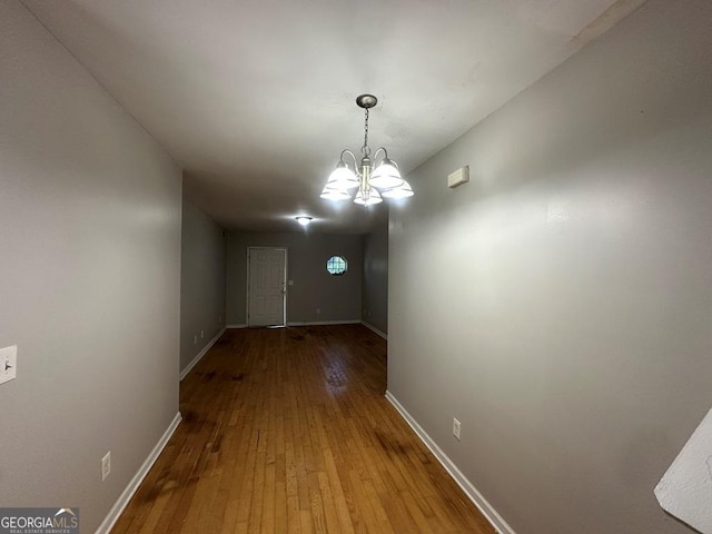 1017 Wheel House Ln Unit D, Monroe, GA 30655 - unfurnished dining area featuring wood-type flooring and a chandelier