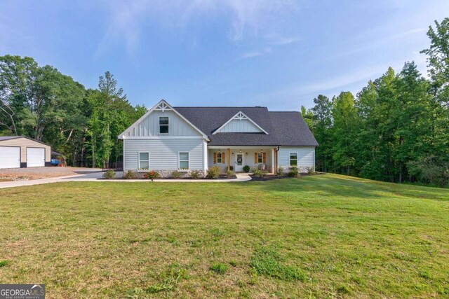 1111 Mcleods Estates Dr, Monroe, GA 30655 - modern farmhouse with board and batten siding, a front yard, and a detached garage