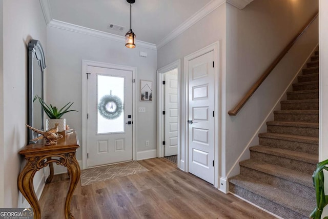 1111 Mcleods Estates Dr, Monroe, GA 30655 - entrance foyer with stairway, wood finished floors, and crown molding