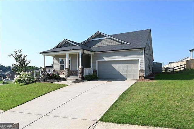 1057 Towne Mill Xing, Canton, GA 30114 - craftsman-style house with covered porch, concrete driveway, a garage, and stone siding