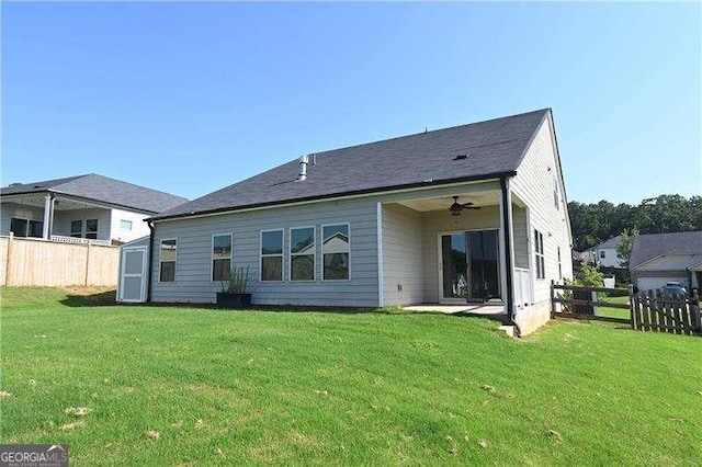 1057 Towne Mill Xing, Canton, GA 30114 - back of property featuring a fenced backyard, ceiling fan, and a storage unit