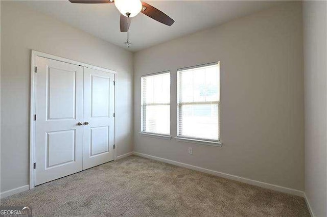 1057 Towne Mill Xing, Canton, GA 30114 - unfurnished bedroom featuring light colored carpet, a closet, and ceiling fan