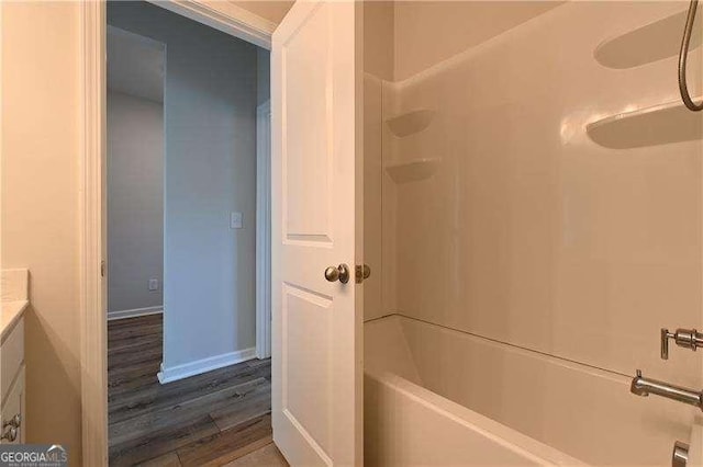 1057 Towne Mill Xing, Canton, GA 30114 - bathroom with vanity, wood finished floors, and shower / washtub combination