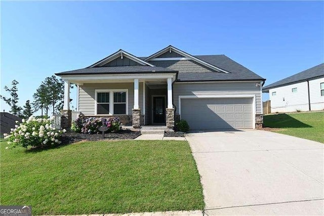 1057 Towne Mill Xing, Canton, GA 30114 - craftsman inspired home with an attached garage, concrete driveway, a front lawn, covered porch, and stone siding