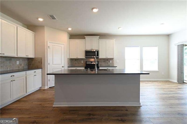 1057 Towne Mill Xing, Canton, GA 30114 - kitchen with stainless steel appliances, dark countertops, wood finished floors, backsplash, and recessed lighting