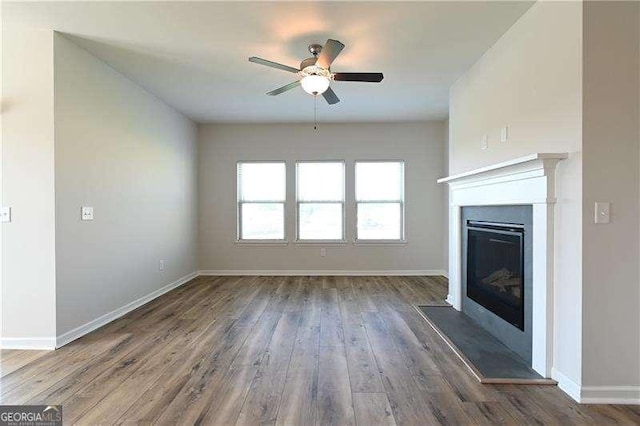 1057 Towne Mill Xing, Canton, GA 30114 - unfurnished living room featuring ceiling fan, a glass covered fireplace, and wood finished floors