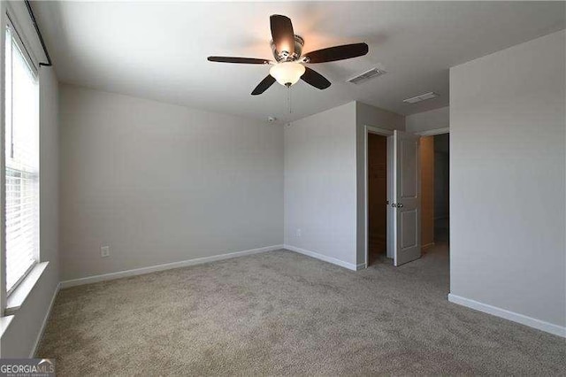 1057 Towne Mill Xing, Canton, GA 30114 - empty room with healthy amount of natural light, ceiling fan, and carpet flooring