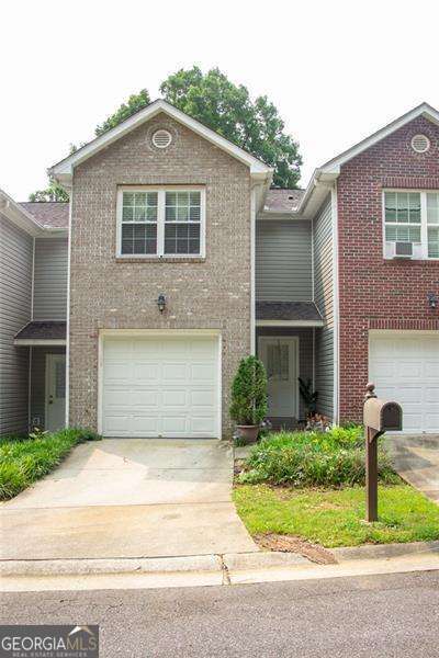 5590 Stonewood Ct, Norcross, GA 30093 - traditional home with brick siding, concrete driveway, and an attached garage