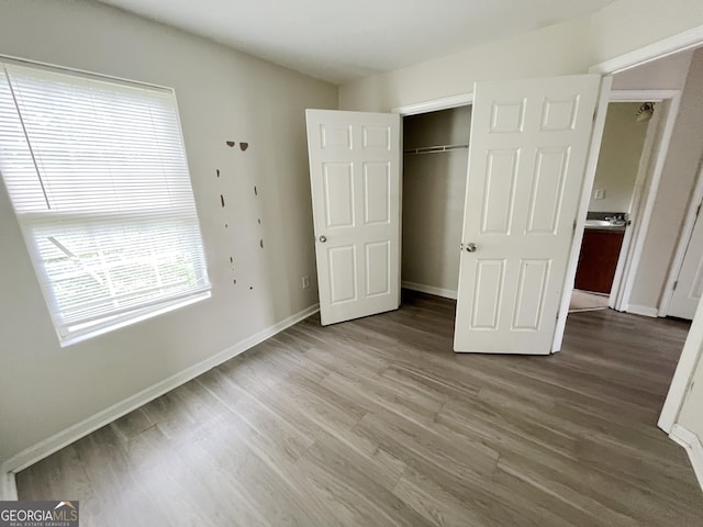 1042 Wheel House Ln Unit C, Monroe, GA 30655 - unfurnished bedroom featuring wood finished floors and a closet
