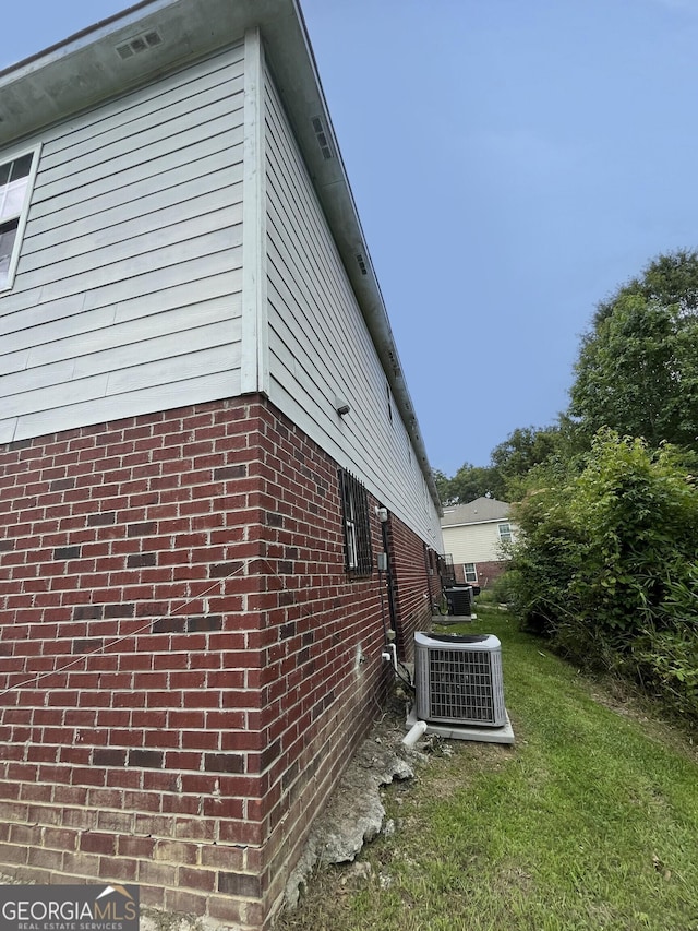 1042 Wheel House Ln Unit C, Monroe, GA 30655 - view of property exterior featuring brick siding and a lawn