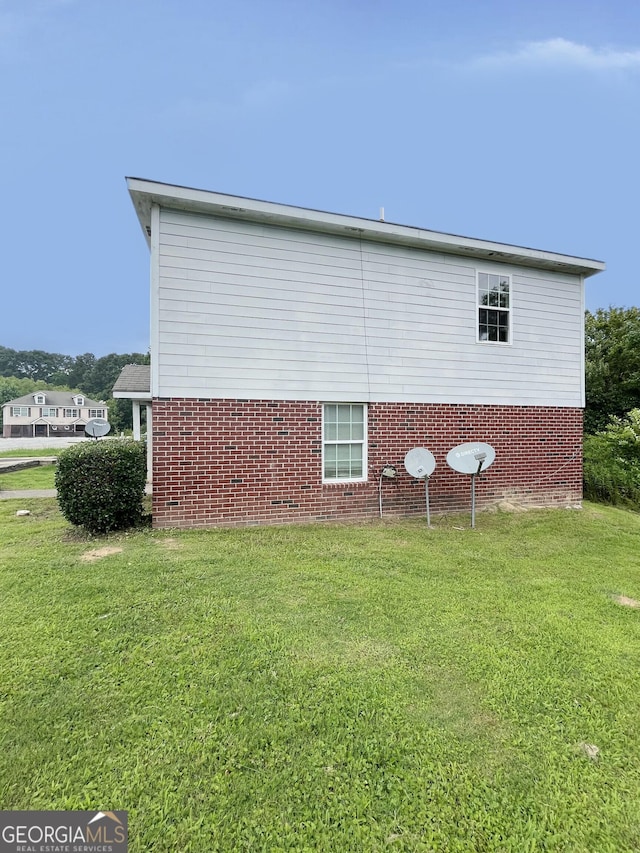 1042 Wheel House Ln Unit C, Monroe, GA 30655 - view of home's exterior with brick siding and a yard