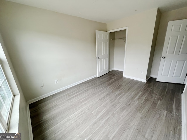 1042 Wheel House Ln Unit C, Monroe, GA 30655 - unfurnished bedroom with wood finished floors and a closet