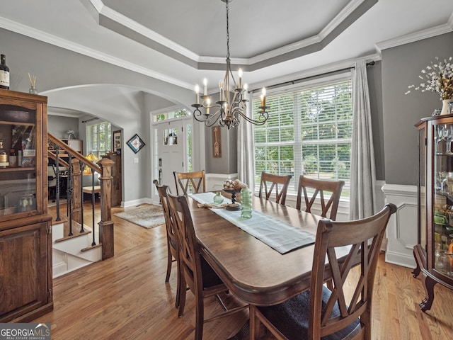302 Thornhill Cir, Jefferson, GA 30549 - dining space featuring arched walkways, a raised ceiling, a chandelier, light wood finished floors, and ornamental molding