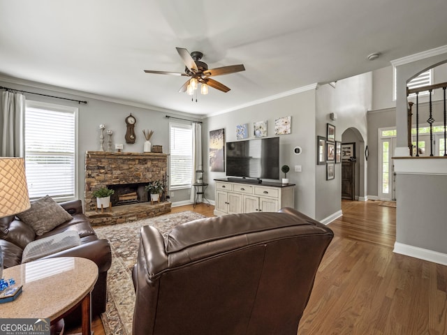 302 Thornhill Cir, Jefferson, GA 30549 - living area with arched walkways, a ceiling fan, a fireplace, wood finished floors, and ornamental molding