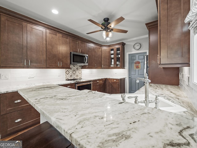 302 Thornhill Cir, Jefferson, GA 30549 - kitchen with appliances with stainless steel finishes, ornamental molding, ceiling fan, light stone counters, and backsplash