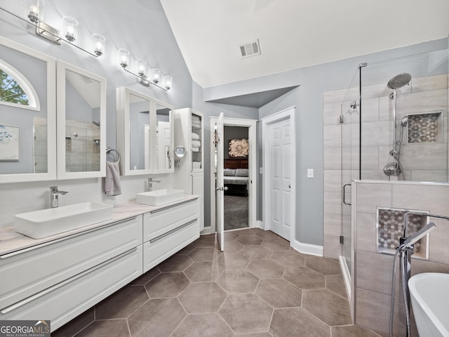 302 Thornhill Cir, Jefferson, GA 30549 - ensuite bathroom featuring a stall shower, double vanity, a freestanding bath, lofted ceiling, and tile patterned floors