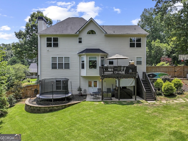 302 Thornhill Cir, Jefferson, GA 30549 - back of house with a trampoline, a wooden deck, a patio area, stairs, and a chimney