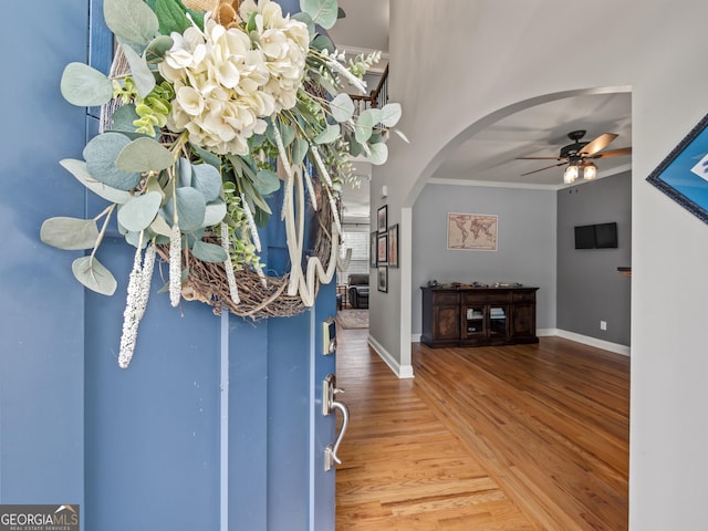 302 Thornhill Cir, Jefferson, GA 30549 - foyer entrance featuring arched walkways, wood finished floors, ceiling fan, and crown molding