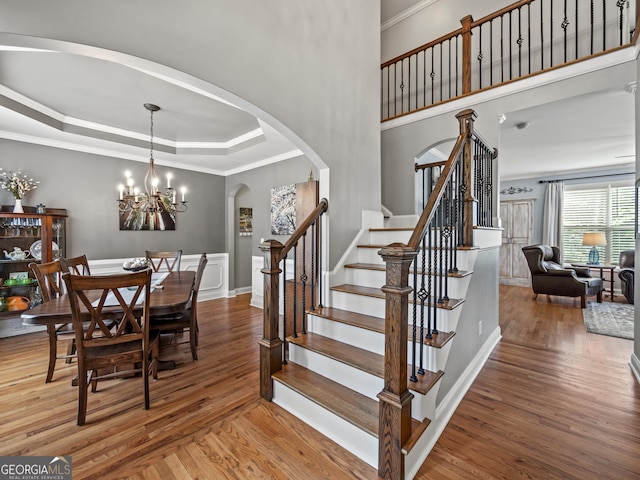 302 Thornhill Cir, Jefferson, GA 30549 - dining area with arched walkways, stairs, wood finished floors, ornamental molding, and a raised ceiling