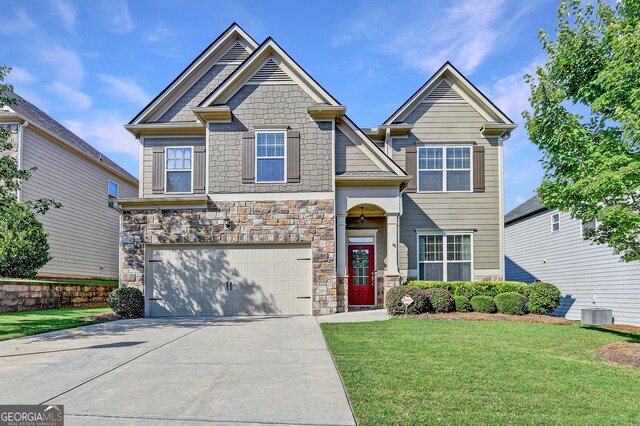 2325 Lake Cove Ct, Buford, GA 30519 - craftsman-style house with stone siding, driveway, a garage, and a front yard