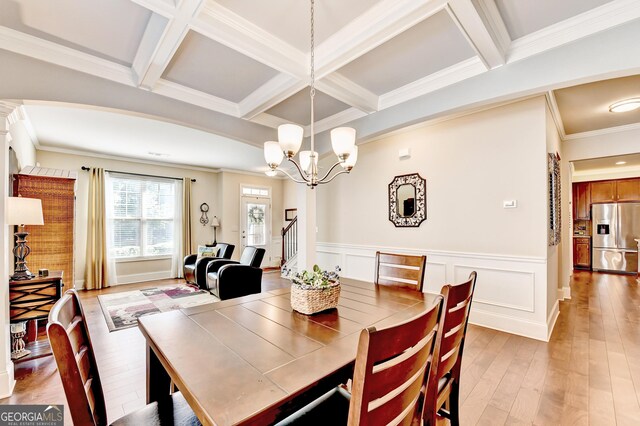 2325 Lake Cove Ct, Buford, GA 30519 - dining area with beam ceiling, coffered ceiling, a chandelier, a wainscoted wall, and light wood-style flooring