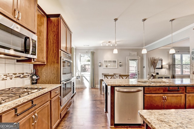 2325 Lake Cove Ct, Buford, GA 30519 - kitchen with stainless steel appliances, crown molding, brown cabinetry, and plenty of natural light