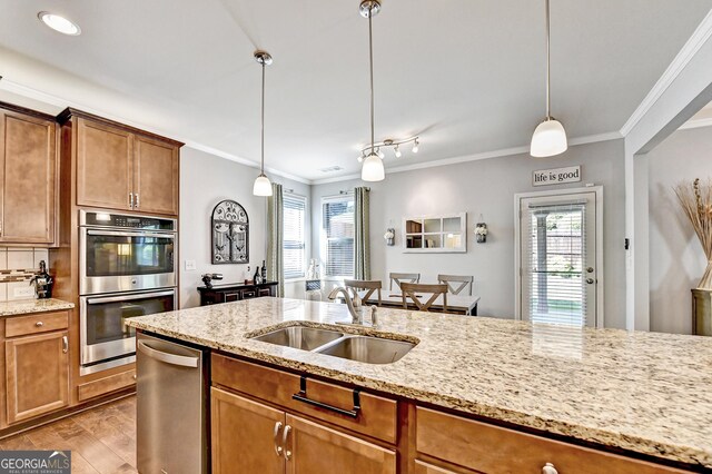 2325 Lake Cove Ct, Buford, GA 30519 - kitchen with stainless steel appliances, ornamental molding, plenty of natural light, decorative light fixtures, and light wood-style flooring