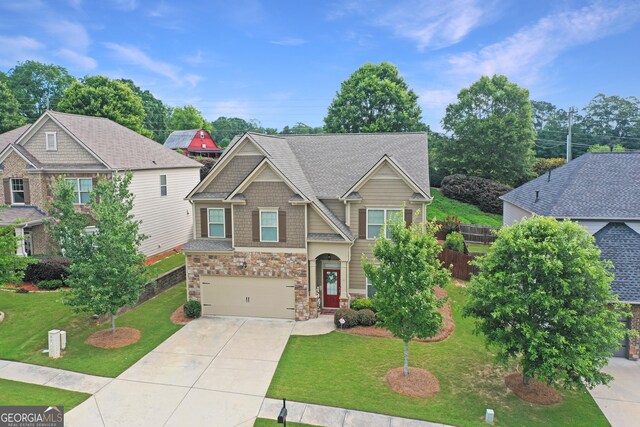 2325 Lake Cove Ct, Buford, GA 30519 - craftsman-style home with driveway, stone siding, a front yard, and an attached garage
