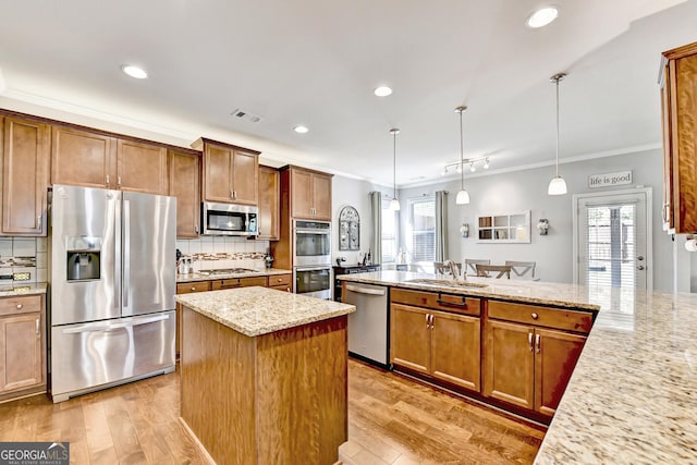 2325 Lake Cove Ct, Buford, GA 30519 - kitchen featuring appliances with stainless steel finishes, crown molding, light stone counters, recessed lighting, and light wood-type flooring