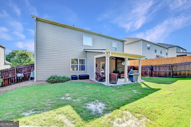 2325 Lake Cove Ct, Buford, GA 30519 - back of property featuring an outdoor hangout area, a patio area, and a fenced backyard