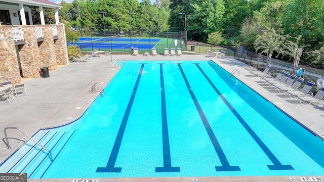 2325 Lake Cove Ct, Buford, GA 30519 - community pool featuring a tennis court and view of scattered trees