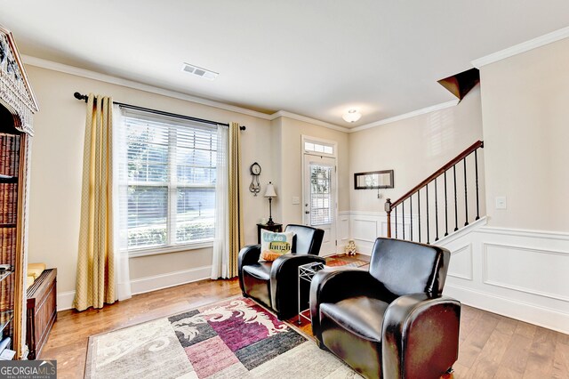 2325 Lake Cove Ct, Buford, GA 30519 - sitting room featuring ornamental molding, stairway, light wood-type flooring, and wainscoting